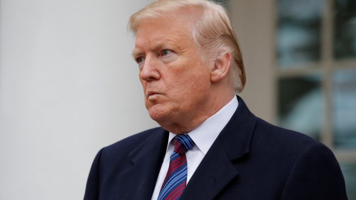 President Trump looks out at repoters after meeting with members of Congress at the White House in Washington