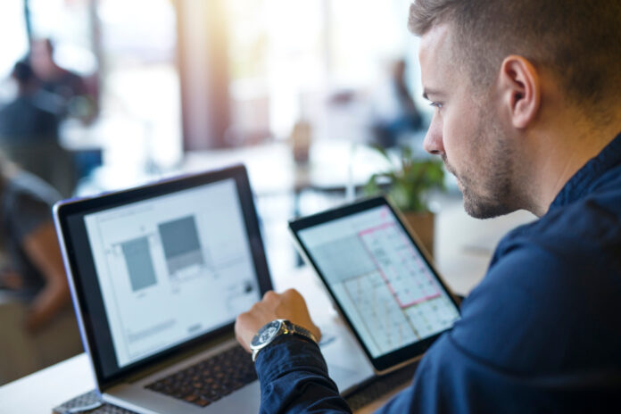 business-man-looking-analyzing-projects-his-laptop-computer-tablet