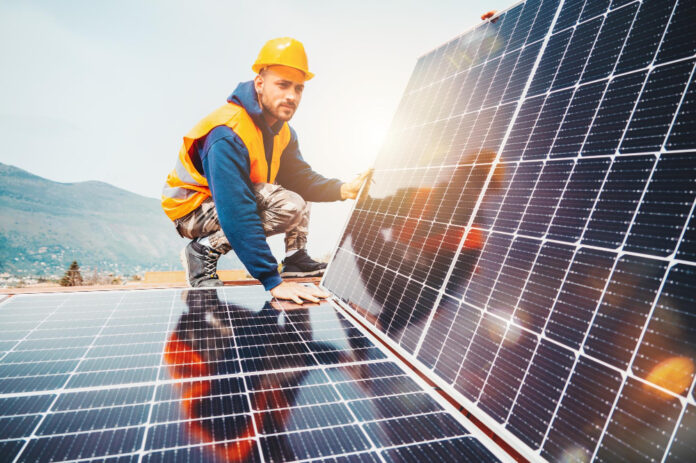 workers-assemble-energy-system-with-solar-panel-electricity